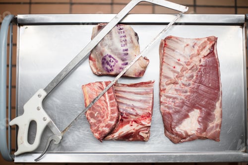 Preview: Meat and saw on cart in butchery