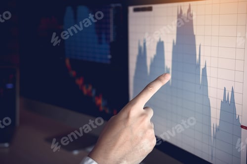 Preview: Close up of hand businessman pointing graph and analysis stock market on computer in office.
