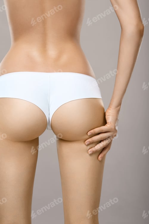 Preview: Unrecognizable woman in underwear testing fat layer on hips