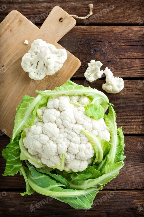 Preview: Fresh whole cauliflower on wooden rustic background, top view