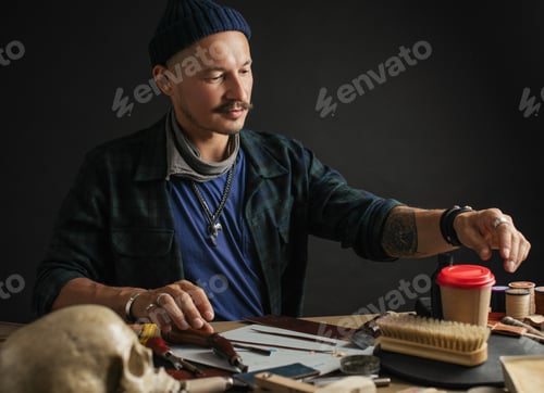 Preview: Shoemaker is repairing shoe. Shoemaker sews shoes. Cobbler workshop.