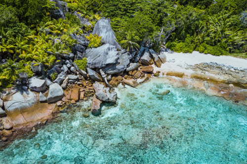 Preview: Aerial drone shot of grand L Anse remote tropical beach at La digue, Seychelles