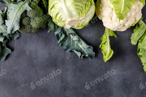 Preview: Fresh farm cabbages on black table background. Green raw vegetables