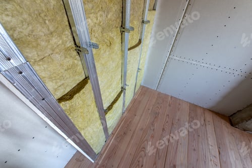 Preview: Wall of a room under renovation with mineral rock wool insulation and metal frame prepared for