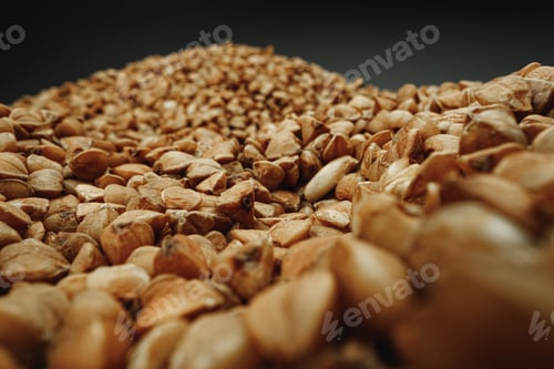 Preview: Macro photo of handful dry buckwheat grain