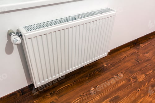 Preview: A white heating radiator on the interior wall