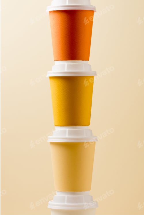 Preview: bright colorful disposable cups isolated on beige background
