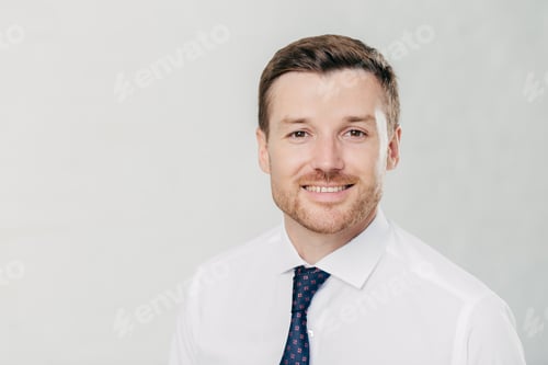 Preview: Attractive young male with cheerful expression, looks confidently at camera