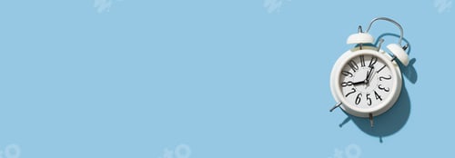 Preview: White alarm clock on empty blue background, minimalism