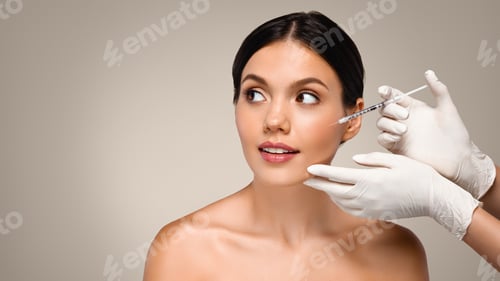 Preview: Cosmetologist professional in white gloves make injection to millennial caucasian lady
