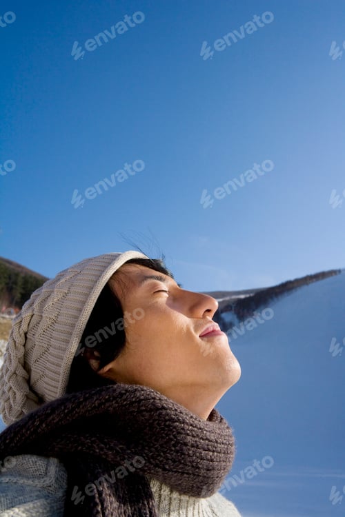 Preview: Young man lifting his face to the sun