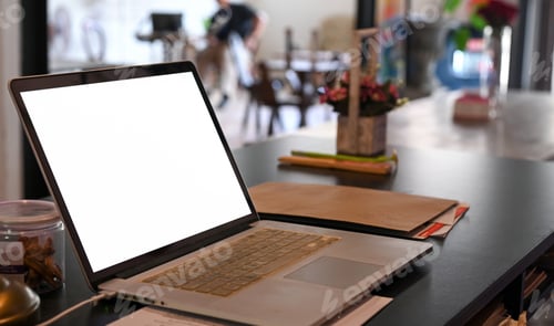 Preview: Close - up shot of Mockup laptop blank screen on a cafe table.