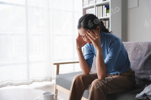 Preview: Tired overworked young woman feeling strong headache, massaging temples