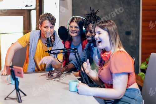 Preview: Group of friends creating online podcast using microphone and smartphone in home studio