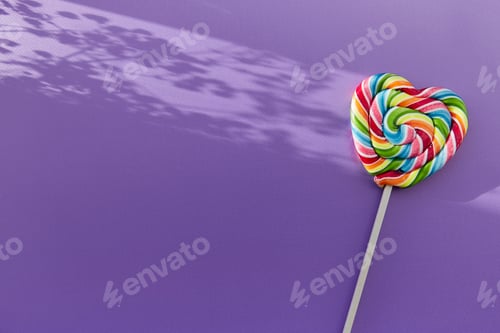 Preview: Bright colorful heart shaped candy on purple background.