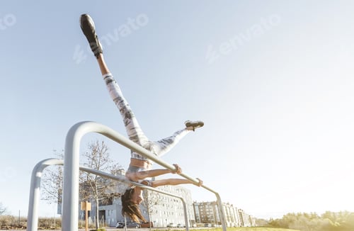 Preview: Woman training on parallel bars on street