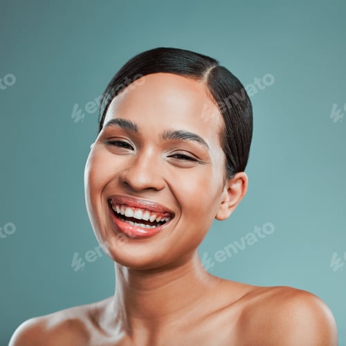 Preview: A young beautiful mixed race woman with smooth soft skin posing and smiling against a green studio