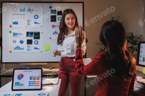 Preview: Businesswomen presenting data and asking questions during meeting