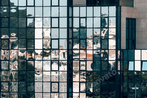 Preview: Reflection of city in glass surface of a building.