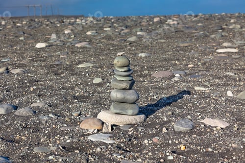 Preview: Pyramid from stones at volcanic beach, Iceland.