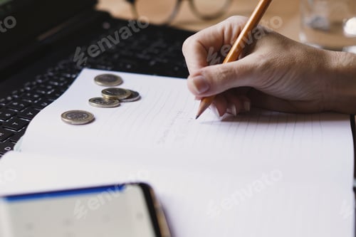 Preview: Closeup shot of an entrepreneur working from home on his personal finances and savings
