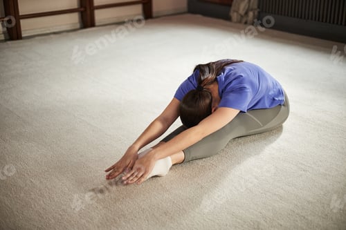 Preview: Teenage Caucasian Girl Stretching Forward during Rhythmic Gymnastics Training