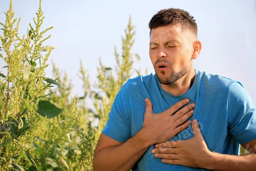 Preview: Man suffering from ragweed allergy outdoors on sunny day