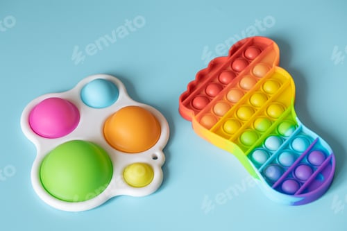 Preview: Two silicone colorful anti-stress toys Pop It and Simple Dimple close up.