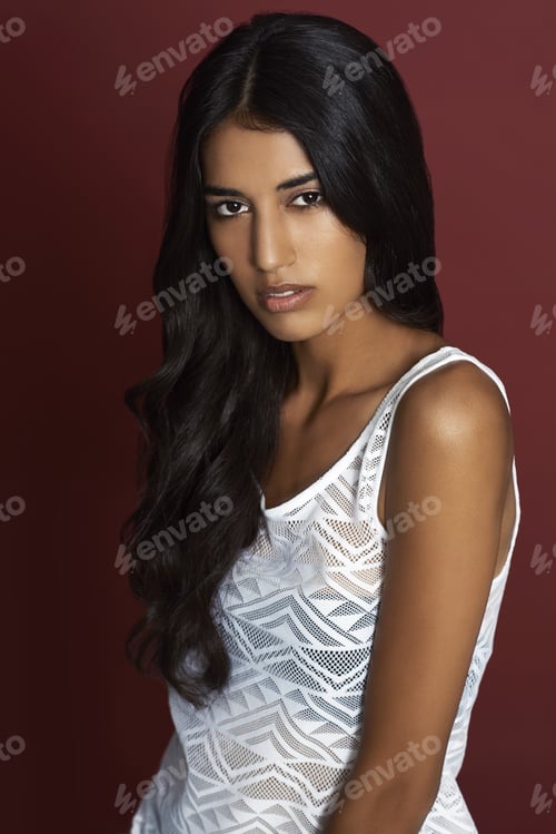 Preview: Simply stunning. Studio portrait of a beautiful young ethnic woman against a red background.