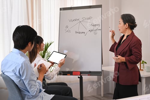 Preview: Confident senior woman executive manager giving business presentation