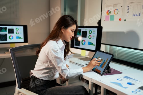 Preview: Business analyst working with data dashboard on tablet