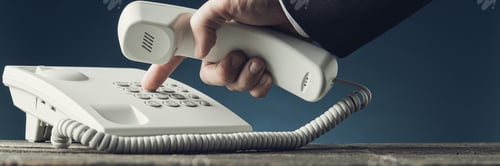 Preview: Wide view image of businessman dialing telephone number