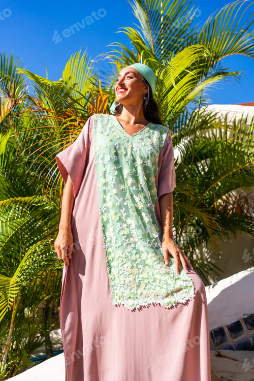 Preview: Low angle of a model standing with a long dress