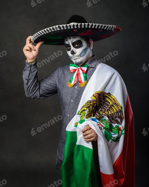 Preview: Portrait of catrin wearing charro hat and showing mexican flag. Day of the dead.