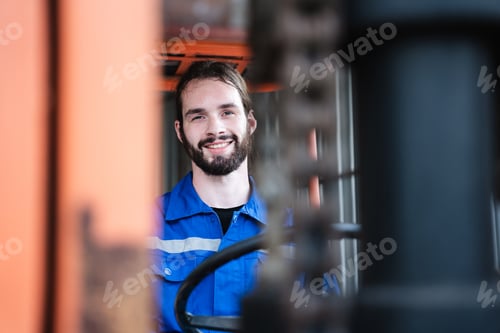 Preview: Portrait of a man working with a forklift in a warehouse. Concept industrial and commercial.