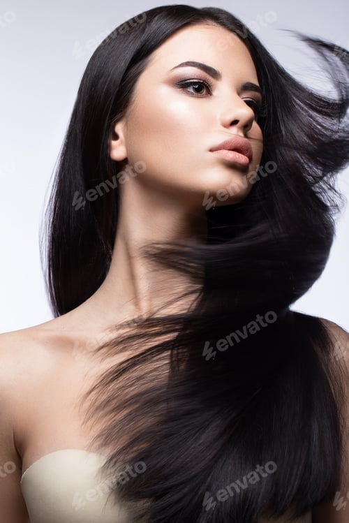 Preview: Beautiful brunette girl in move with a perfectly smooth hair, and classic make-up. Beauty face.