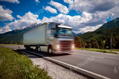 Preview: Fuel truck rushes down the highway in the background the Alps. Truck Car in motion blur.