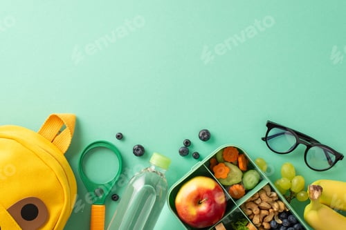 Preview: Embrace healthy lifestyle in school - top view of lunchbox with natural veggies, fruits
