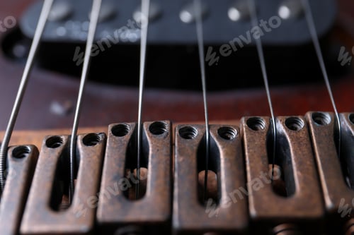 Preview: Closeup view of electric guitar, focus on bridge with strings