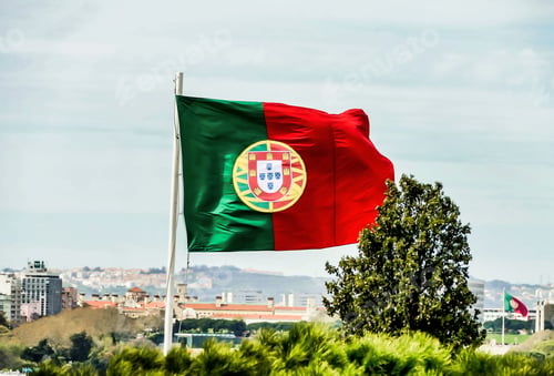 Preview: Flag of Portugal floating in the wind under the blue sky captured in Lisbon, Portugal