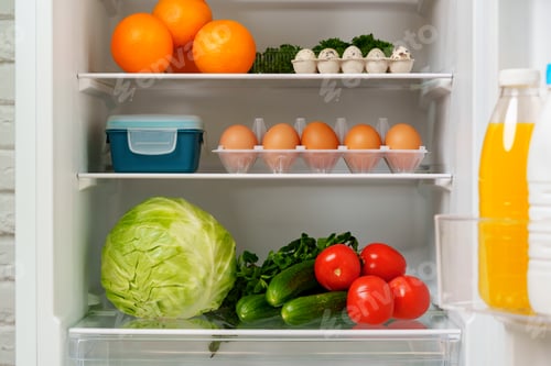 Preview: White Refrigerator Open With Fresh Produce and Dairy