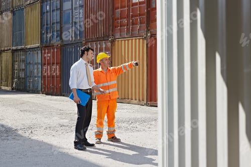 Preview: businessman and manual worker with cargo containers