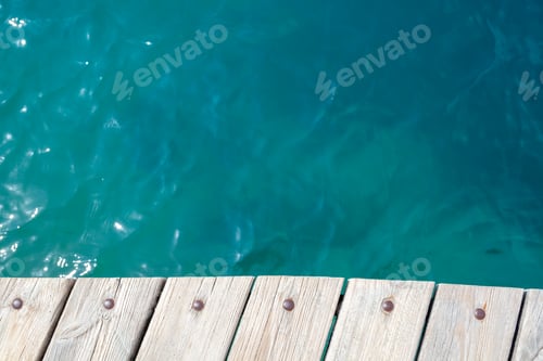 Preview: Wooden planks on the pier above the blue sea. top of the water.