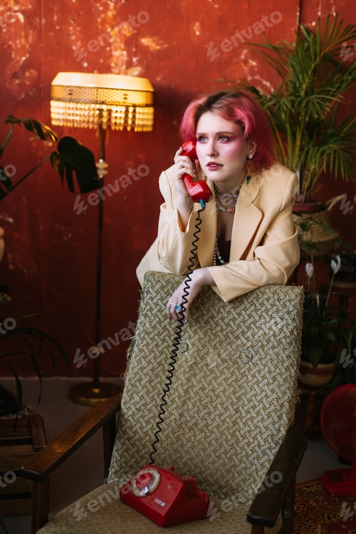 Preview: fashion style portrait young trendy girl holding old phone red color
