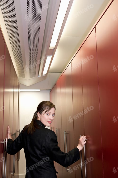 Preview: A business woman in a store cupboard