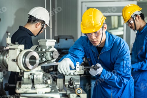Preview: Asian mechanical workers working on milling machine.