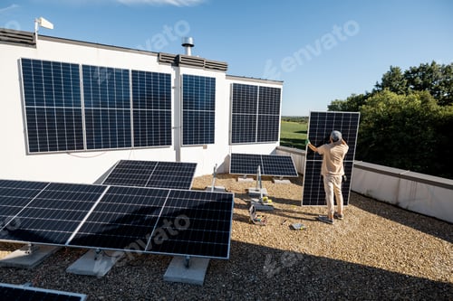 Preview: Man installing solar panels on a rooftop