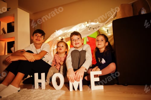 Preview: Kids in tent waching tv at night home. Hygge mood.