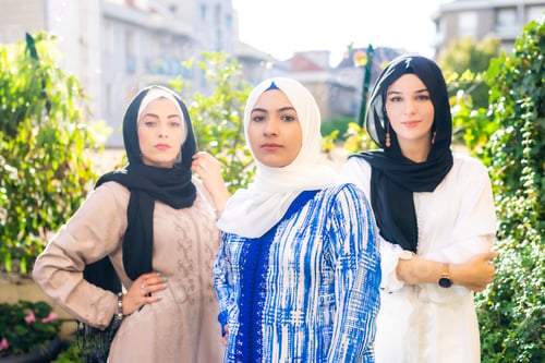 Preview: Three women in hijabs standing confidently outdoors