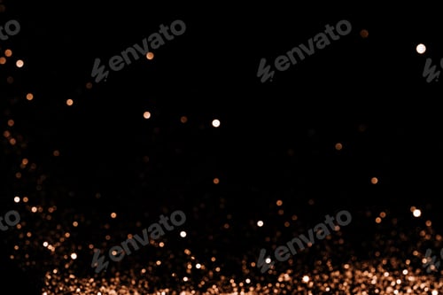 Preview: Blurred sparkles of gold color falling against black background